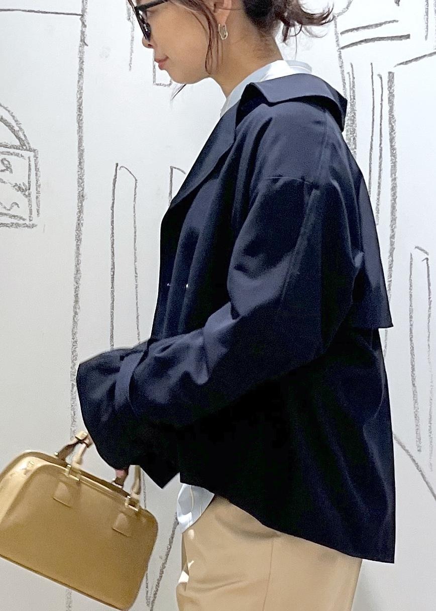 ベージュ系のボストンバッグ、ホワイト系のスウェット、ベージュ系のチノパンツを着用したレディースの春コーディネートの7枚目の写真