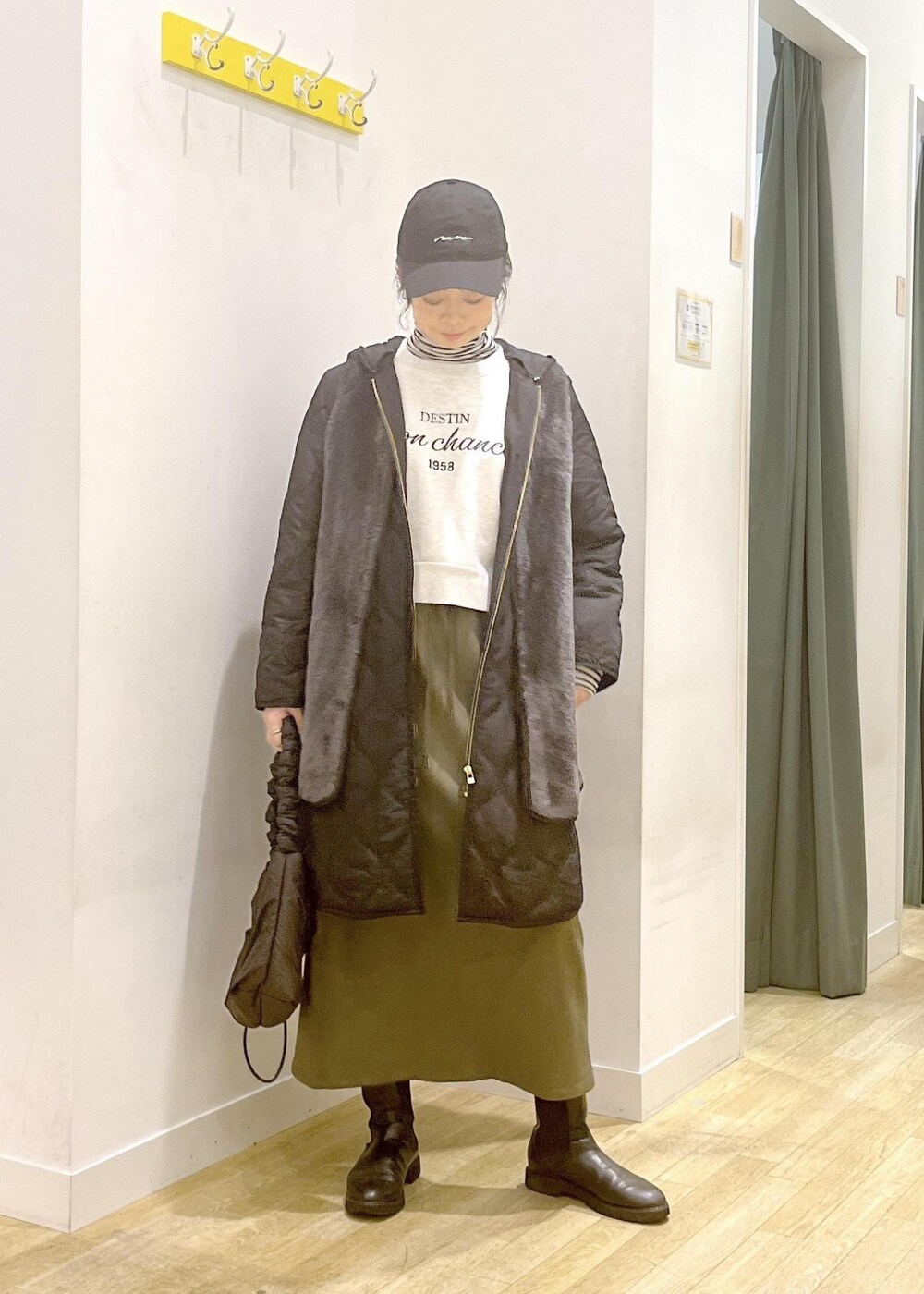 ホワイト系のTシャツ/カットソー、ベージュ系のボディバッグ/ウエストポーチ、ブラック系のその他アウターを着用したレディースの冬コーディネートの2枚目の写真