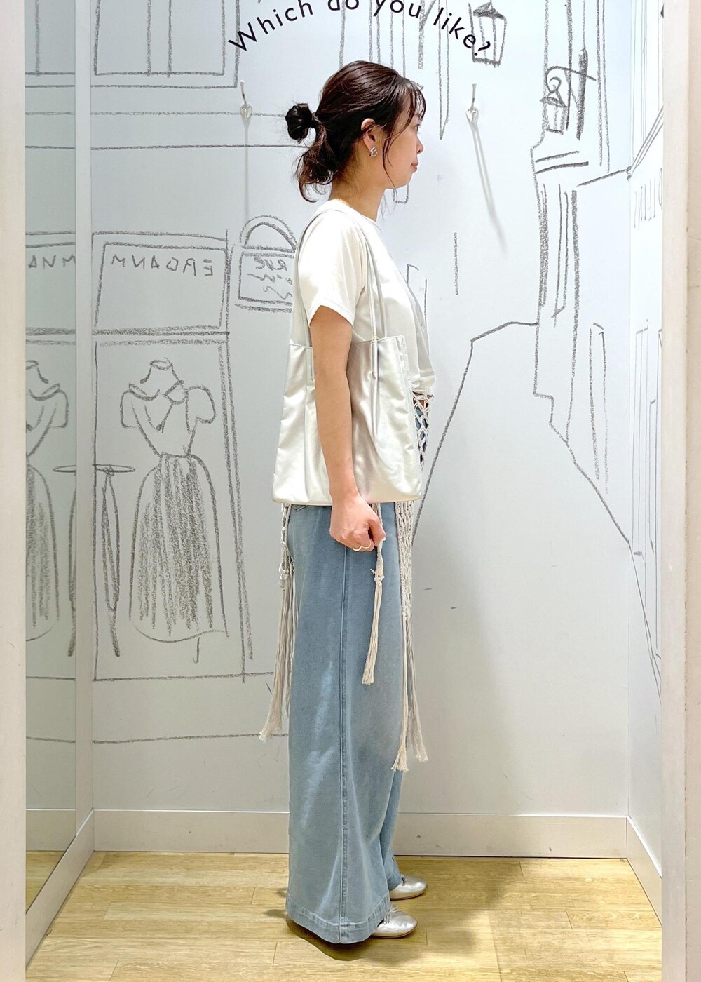 シルバー系のバレエシューズ、シルバー系のトートバッグ、ブルー系のデニムパンツを着用したレディースの春コーディネートの6枚目の写真