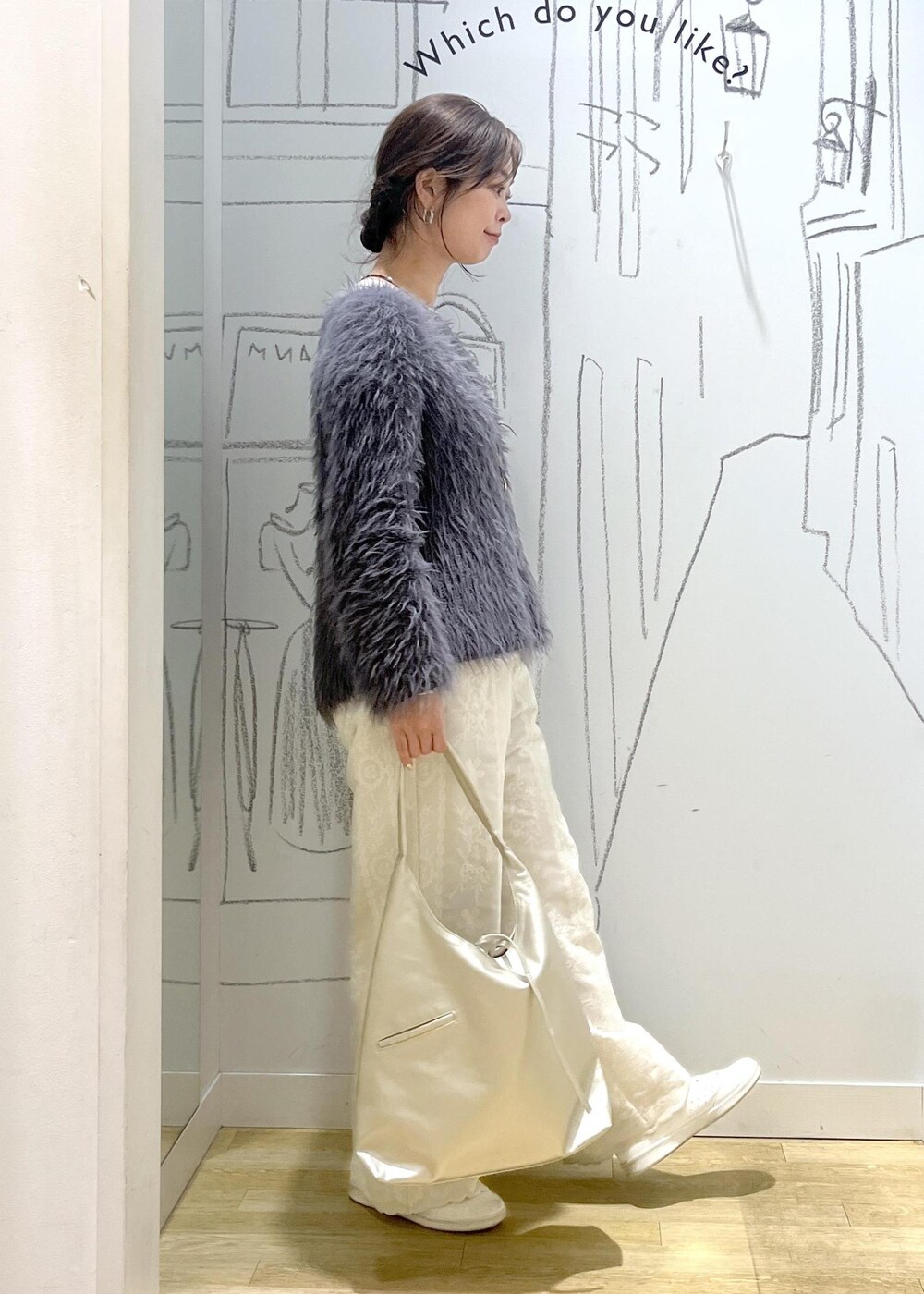 ホワイト系のスニーカー、ホワイト系のTシャツ/カットソー、グレー系のニット/セーターを着用したレディースの冬コーディネートの6枚目の写真