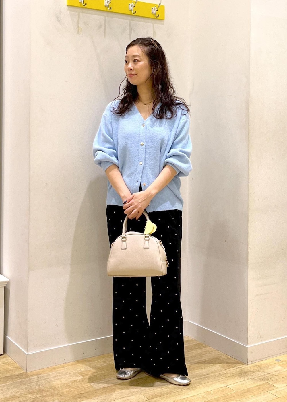 ブルー系のカーディガン/ボレロ、ベージュ系のボストンバッグ、ブラック系のその他パンツを着用したレディースの秋コーディネートの2枚目の写真