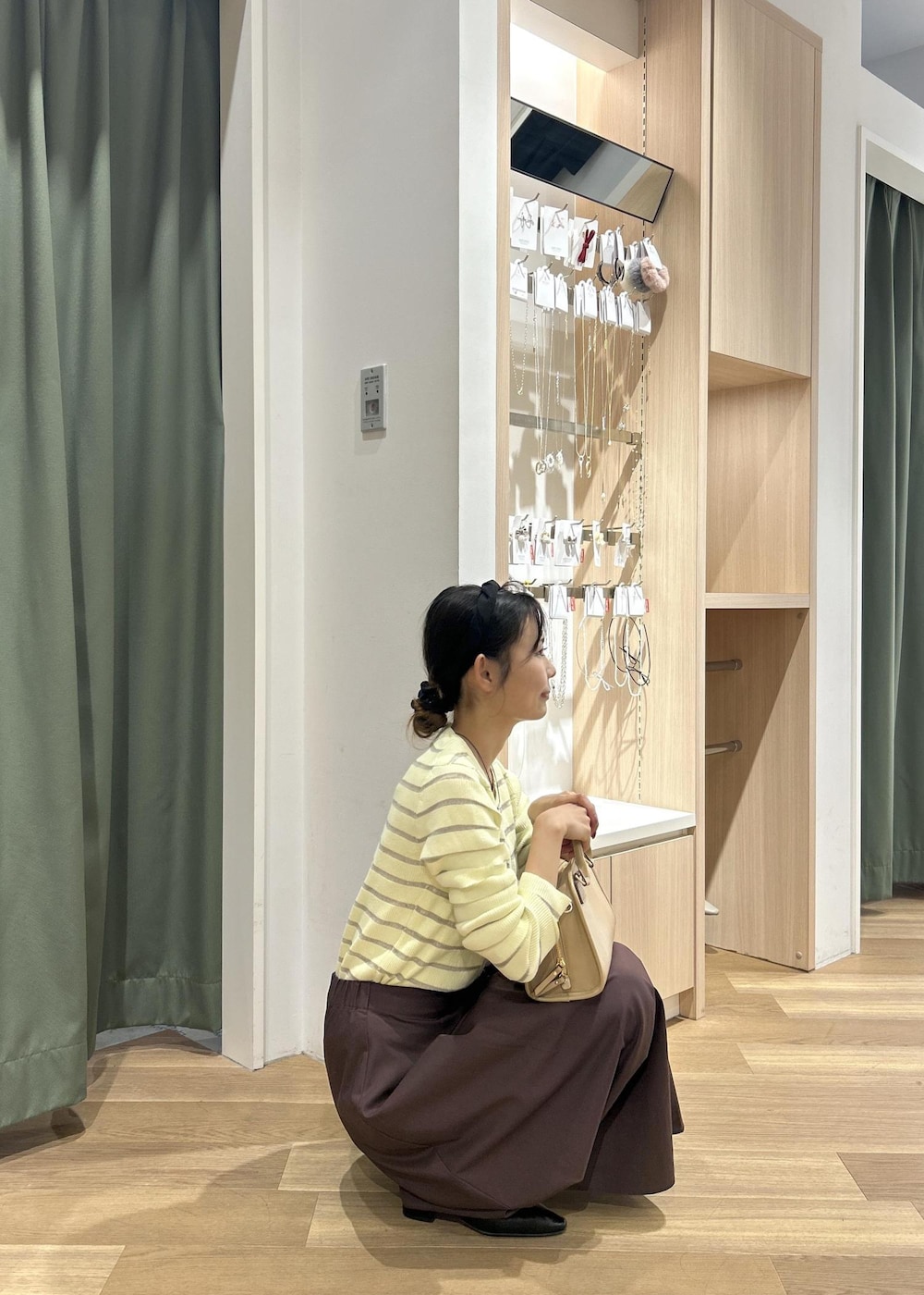 ベージュ系のボストンバッグ、ベージュ系のカーディガン/ボレロ、ブラック系のパンプスを着用したレディースの春コーディネートの7枚目の写真