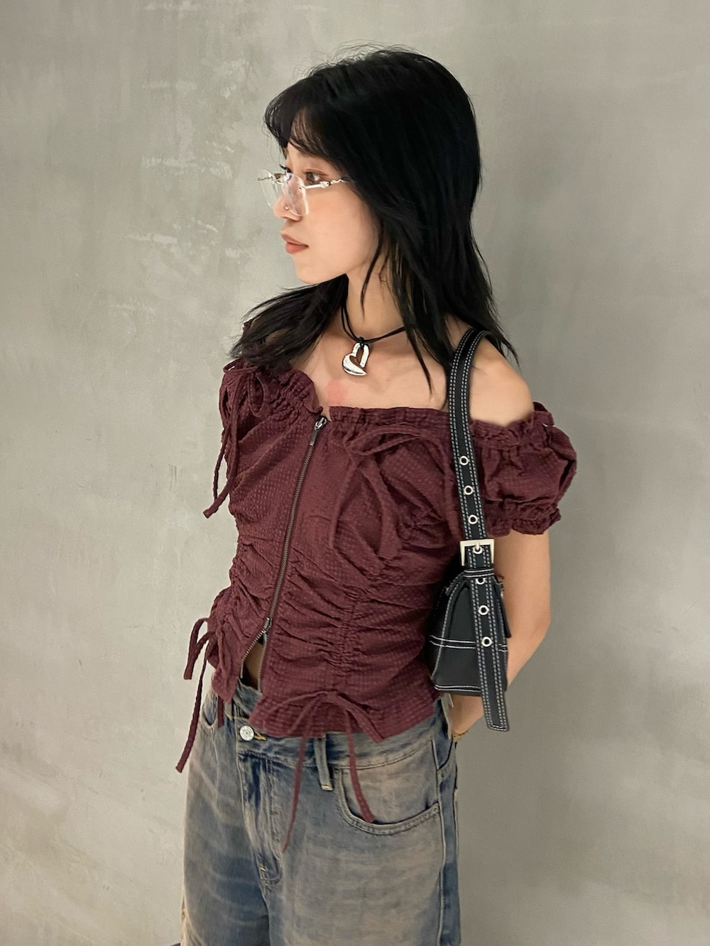 レッド系のシャツ/ブラウス、ブルー系のデニムパンツ、ブラック系のショルダーバッグを着用したレディースの夏コーディネートの2枚目の写真