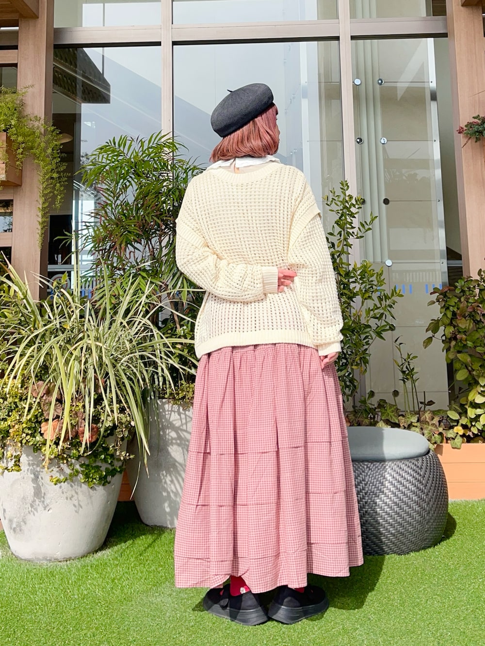 レッド系のスカートを着用したレディースの夏コーディネートの3枚目の写真