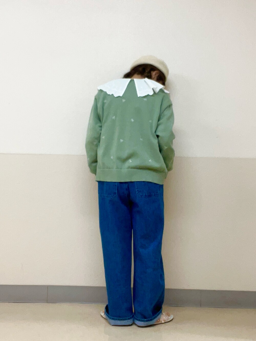 グリーン系のカーディガン/ボレロ、ホワイト系のシャツ/ブラウス、ブルー系のオールインワン・サロペットを着用したレディースの春コーディネートの3枚目の写真