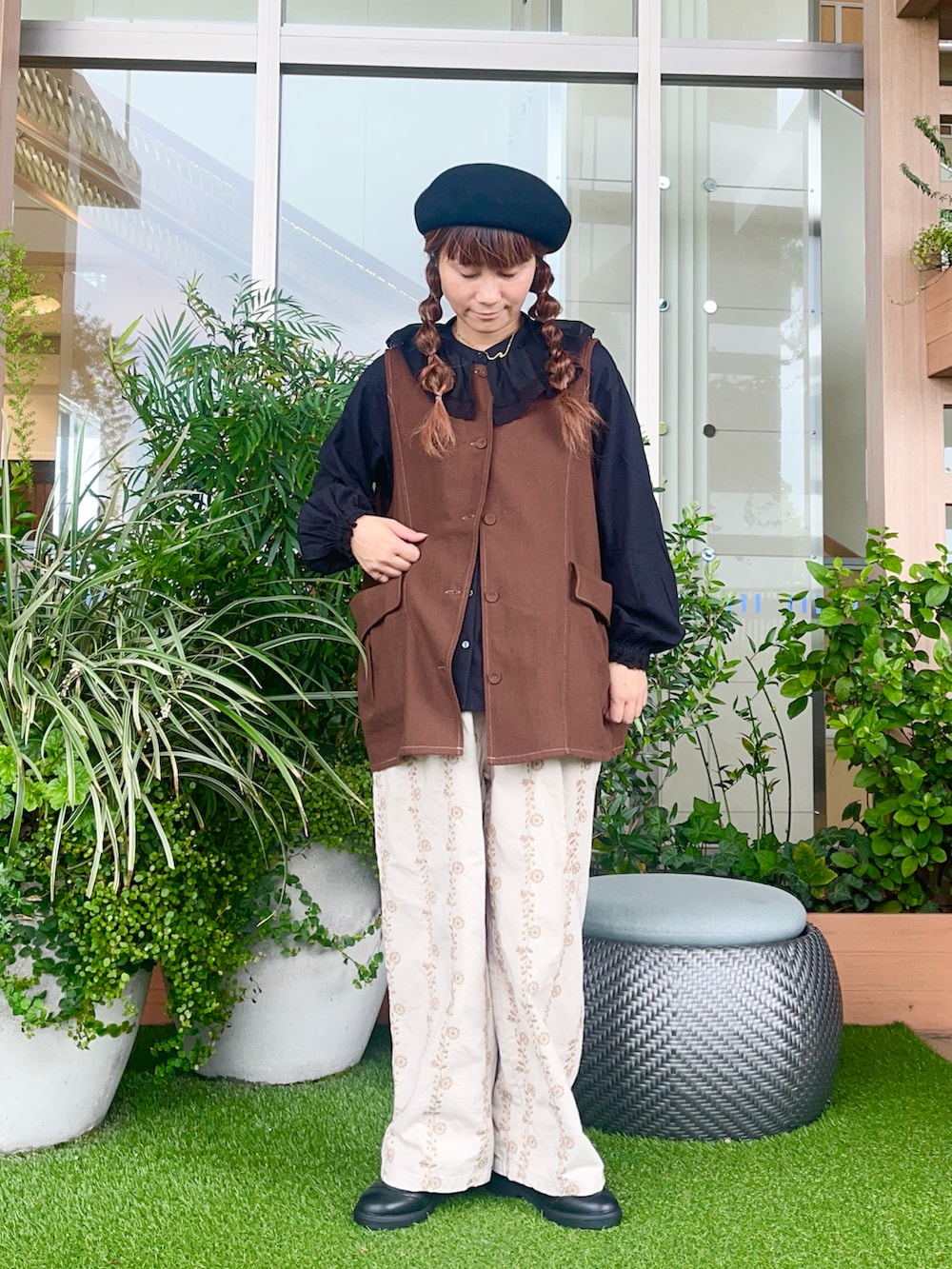 ブラウン系のベストを着用したレディースの冬コーディネートの2枚目の写真