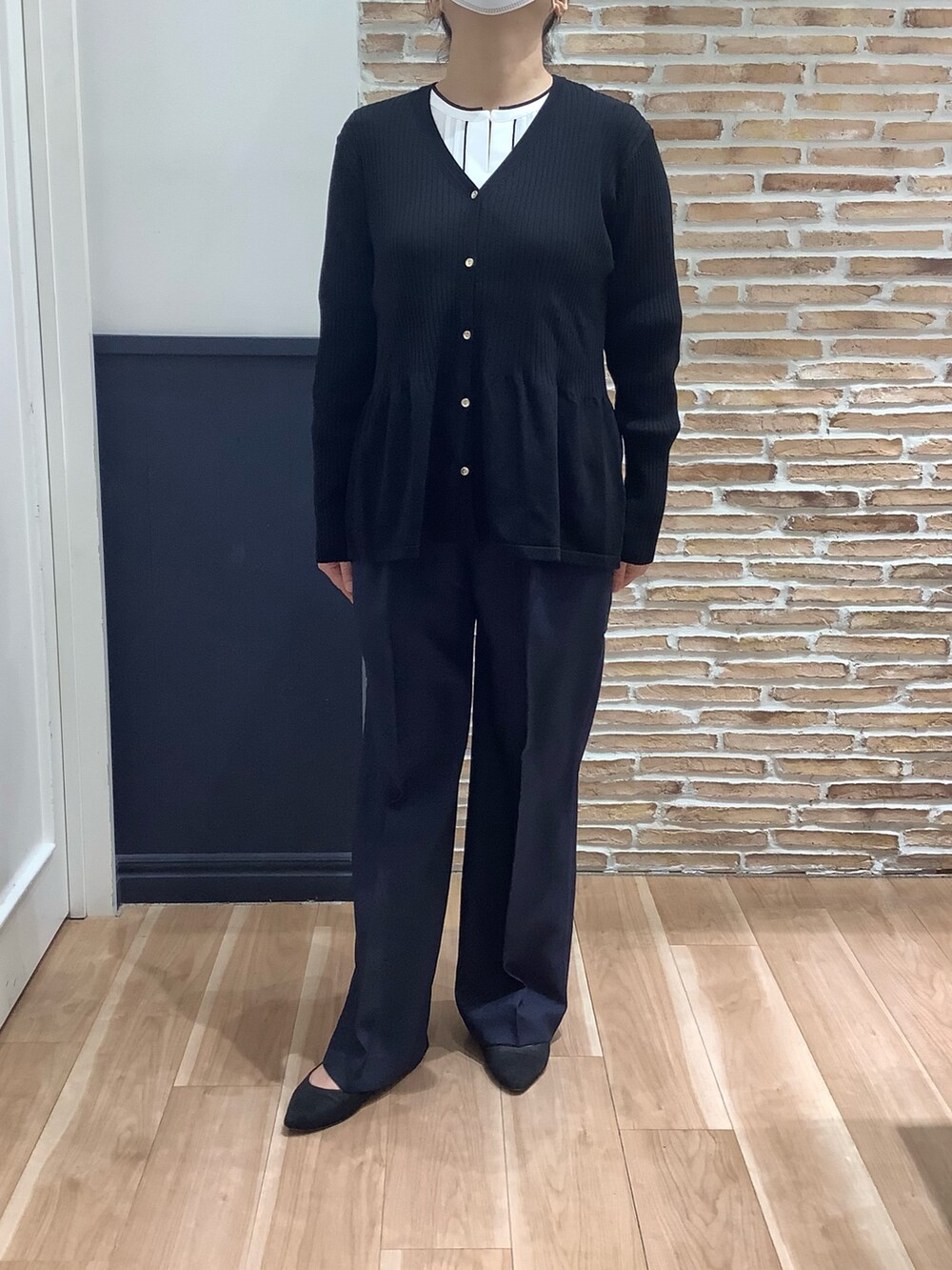 ブルー系のカーディガン/ボレロ、ブルー系のスラックス、ホワイト系のシャツ/ブラウスを着用したレディースの冬コーディネートの2枚目の写真