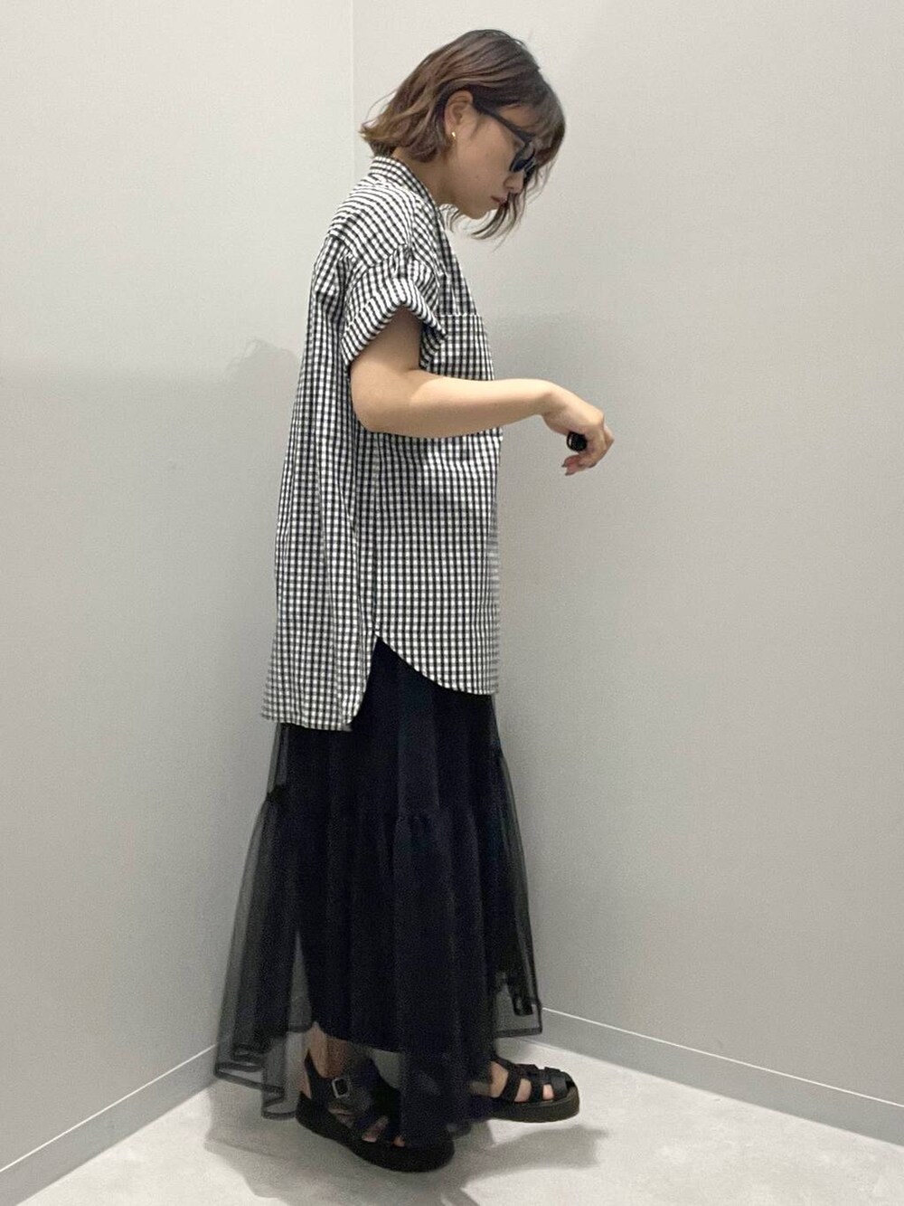 グレー系のシャツ/ブラウス、ブラック系のスカートを着用したレディースの春コーディネートの2枚目の写真