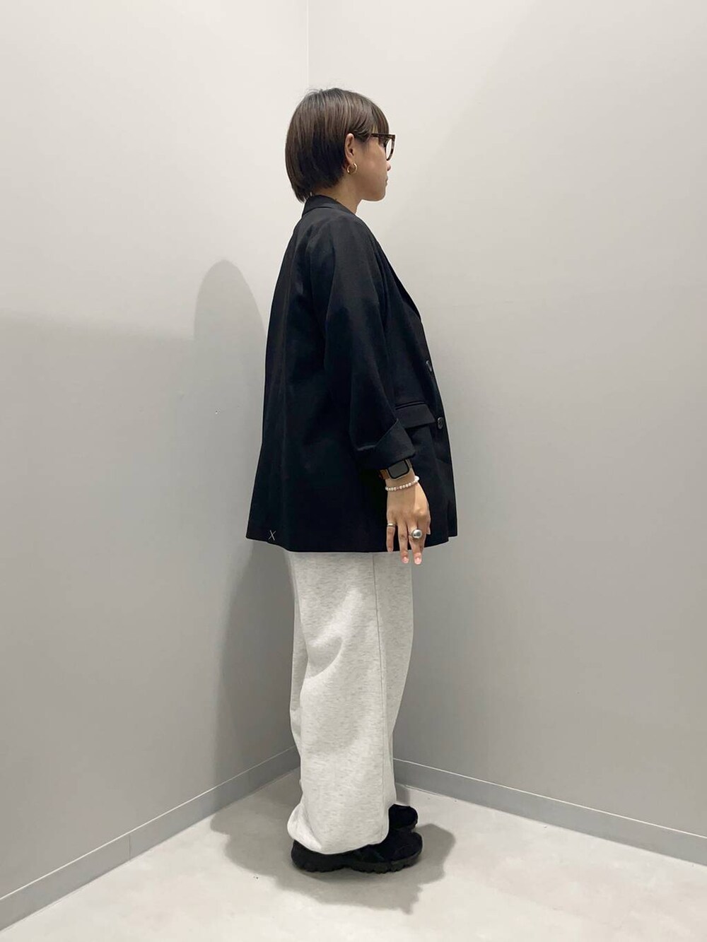 ブラック系のテーラードジャケット、グレー系のスウェットパンツ、レッド系のTシャツ/カットソーを着用したレディースの春コーディネートの4枚目の写真