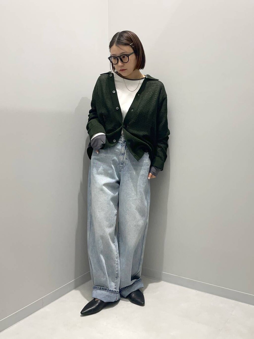 ブルー系のデニムパンツ、ホワイト系のTシャツ/カットソー、グリーン系のカーディガン/ボレロを着用したレディースの春コーディネートの2枚目の写真