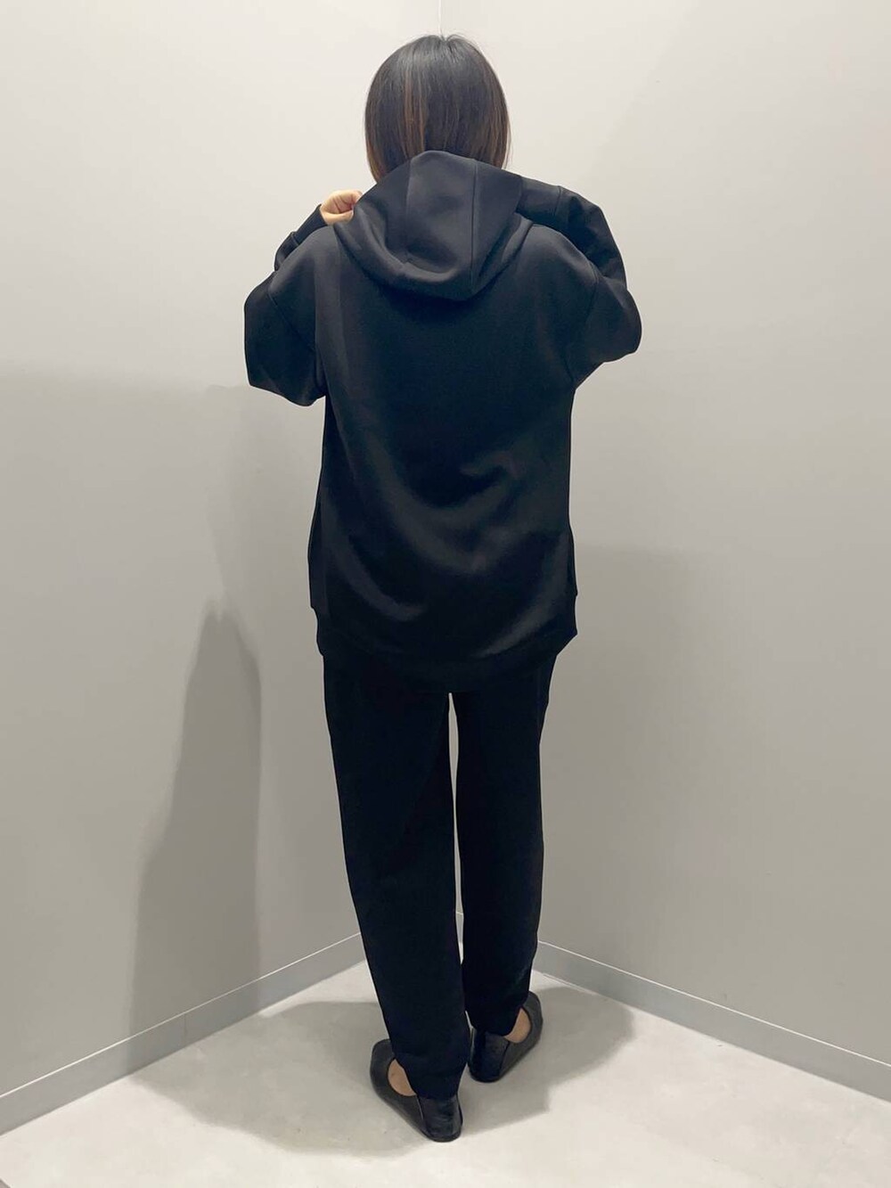 ブラック系のパーカー、ブラック系のスウェットパンツを着用したレディースの秋コーディネートの4枚目の写真