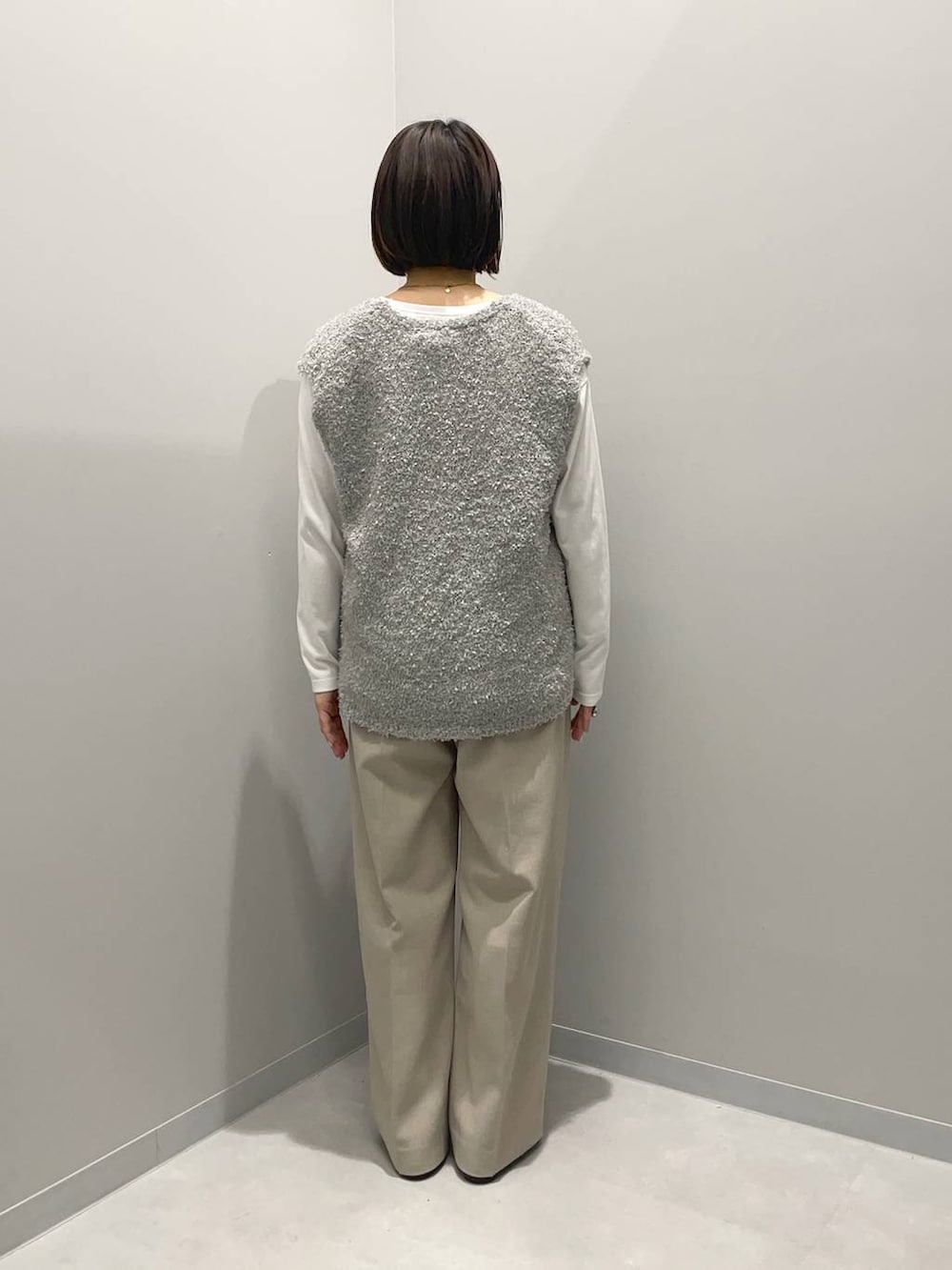 ブラウン系のショルダーバッグ、ベージュ系のその他パンツ、グレー系のベストを着用したレディースの春コーディネートの4枚目の写真