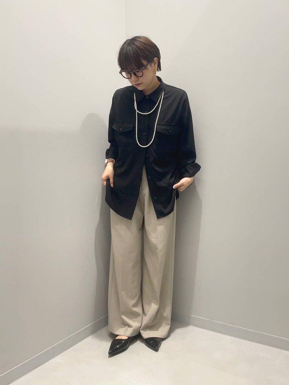 ベージュ系のその他パンツ、ブラック系のシャツ/ブラウスを着用したレディースの春コーディネートの2枚目の写真