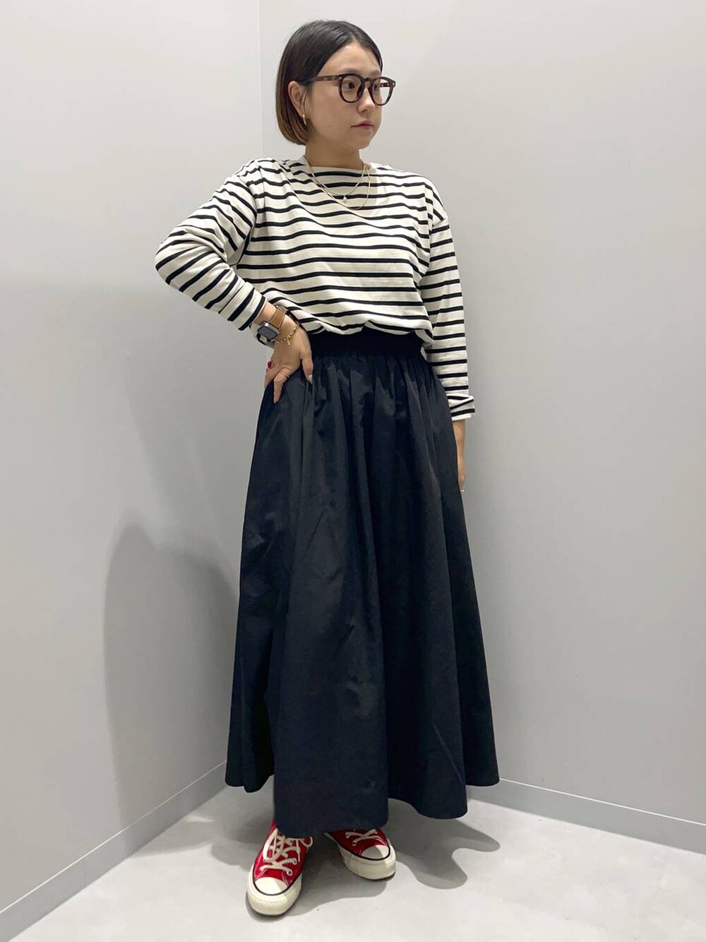 ブラック系のスカート、グレー系のTシャツ/カットソーを着用したレディースの夏コーディネートの2枚目の写真