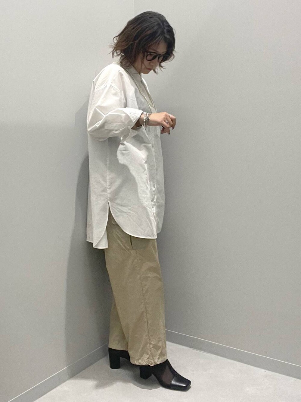 ベージュ系のカーゴパンツ、ホワイト系のシャツ/ブラウスを着用したレディースの春コーディネートの2枚目の写真