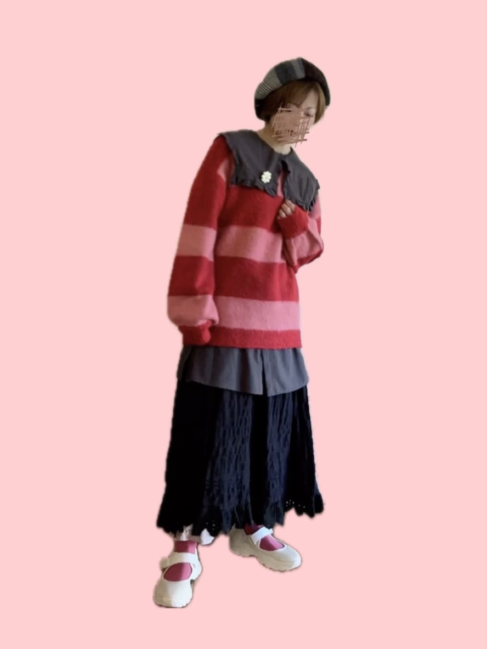 レッド系のニット/セーター、ブラック系のスカート、ベージュ系のスニーカーを着用したレディースの冬コーディネートの4枚目の写真