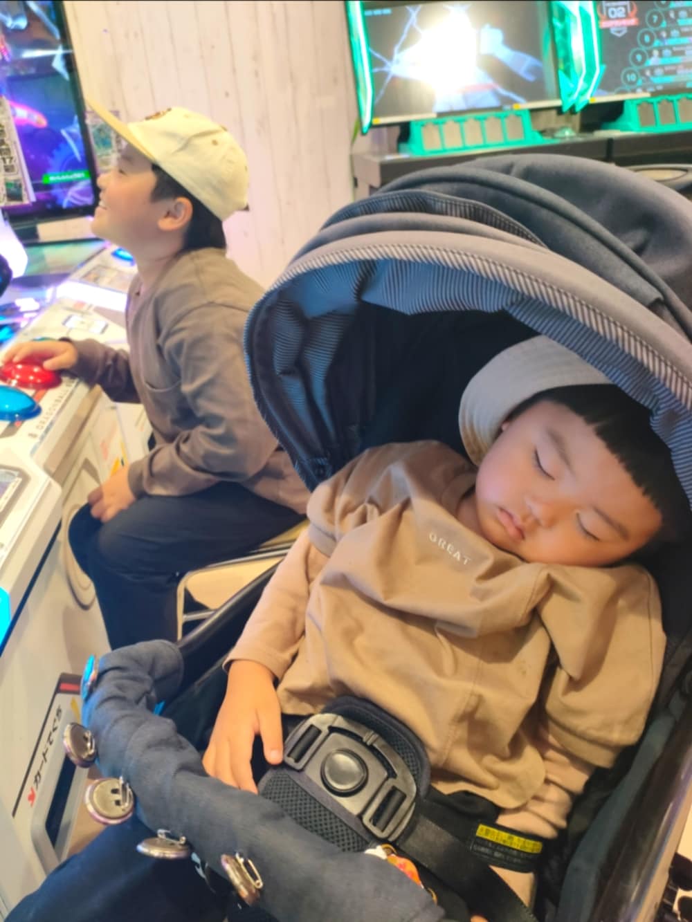 ブラウン系のTシャツ/カットソー、ブラック系のパンツ、ベージュ系のスニーカーを着用したキッズの春コーディネートの3枚目の写真