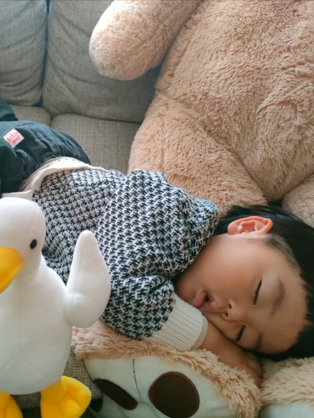 ホワイト系のカーディガン/ボレロ、ブラック系のパンツ、ブラック系のブーツを着用したキッズの冬コーディネートの5枚目の写真