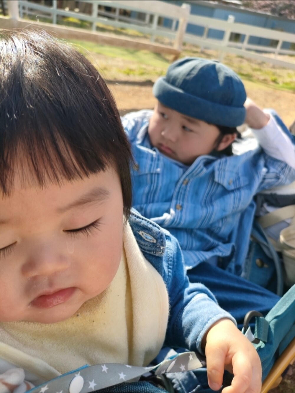 ブルー系のデニムパンツ、ブラック系のスニーカー、ブルー系のシャツ/ブラウスを着用したキッズの春コーディネートの3枚目の写真
