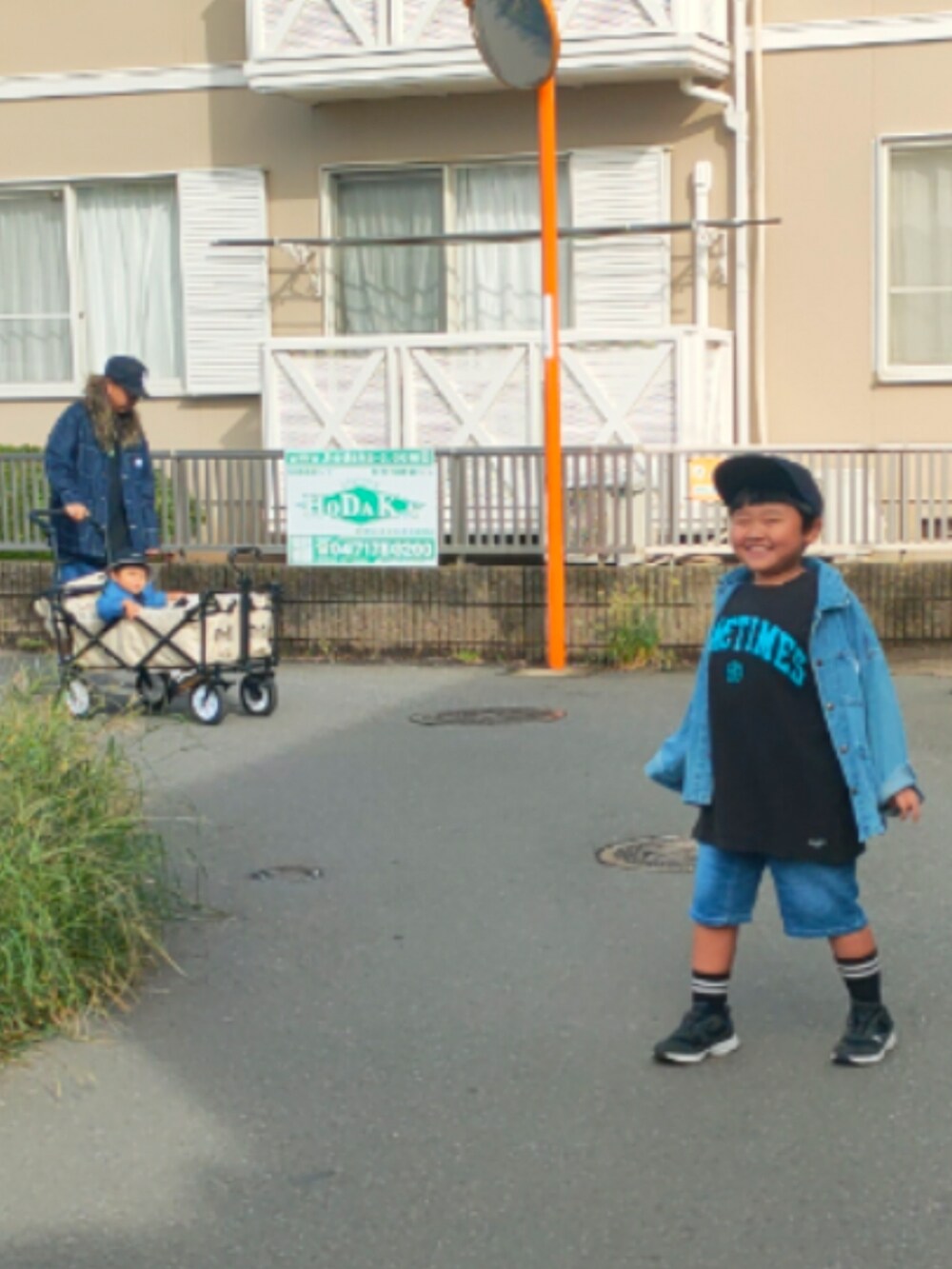 ブルー系のカバーオール、ブラック系のTシャツ/カットソー、ブラック系のスニーカーを着用したキッズの秋コーディネートの5枚目の写真