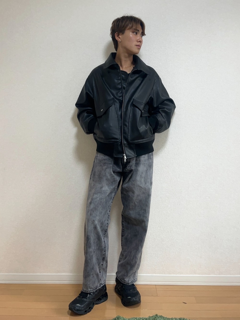 ブラック系のブルゾン、ブラック系のデニムパンツ、ブラック系のスニーカーを着用したメンズの秋コーディネートの2枚目の写真