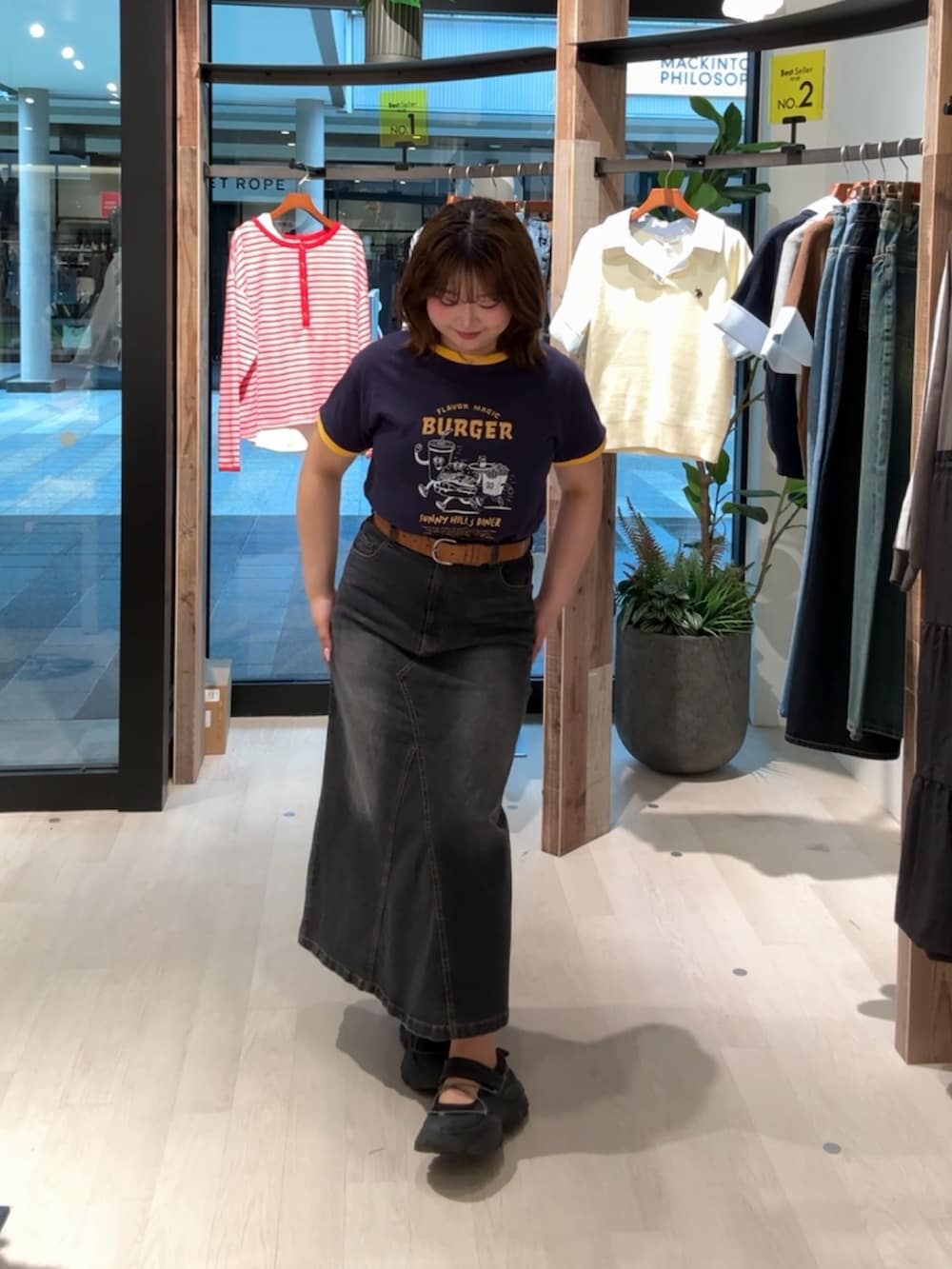 ブルー系のTシャツ/カットソー、ブラック系のスカートを着用したレディースの春コーディネートの3枚目の写真