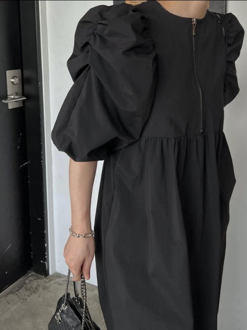 ブラック系のワンピースを着用したレディースの春コーディネートの4枚目の写真