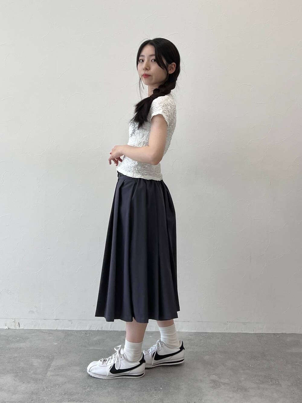 グレー系のスカート、ホワイト系のTシャツ/カットソーを着用したレディースの夏コーディネートの2枚目の写真