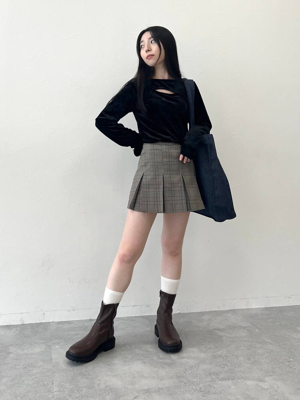 ブラック系のTシャツ/カットソー、ブラウン系のスカート、ブルー系のトートバッグを着用したレディースの冬コーディネートの3枚目の写真