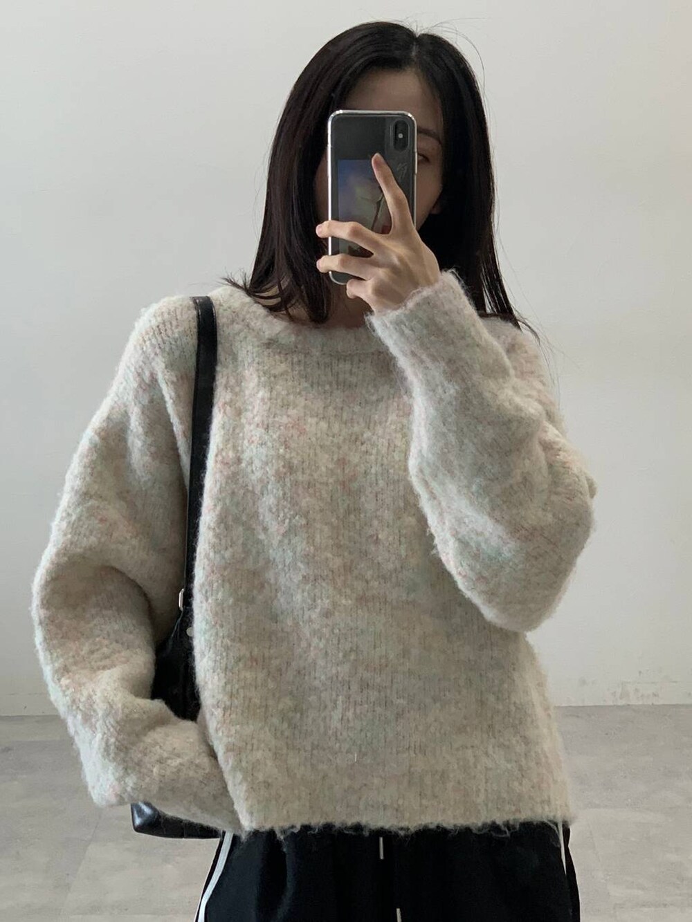 ブラック系のその他パンツ、ホワイト系のニット/セーター、ブラック系のハンドバッグを着用したレディースの秋コーディネートの8枚目の写真