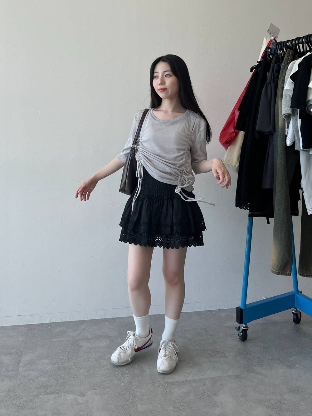 ブラック系のスカート、グレー系のTシャツ/カットソーを着用したレディースの春コーディネートの2枚目の写真