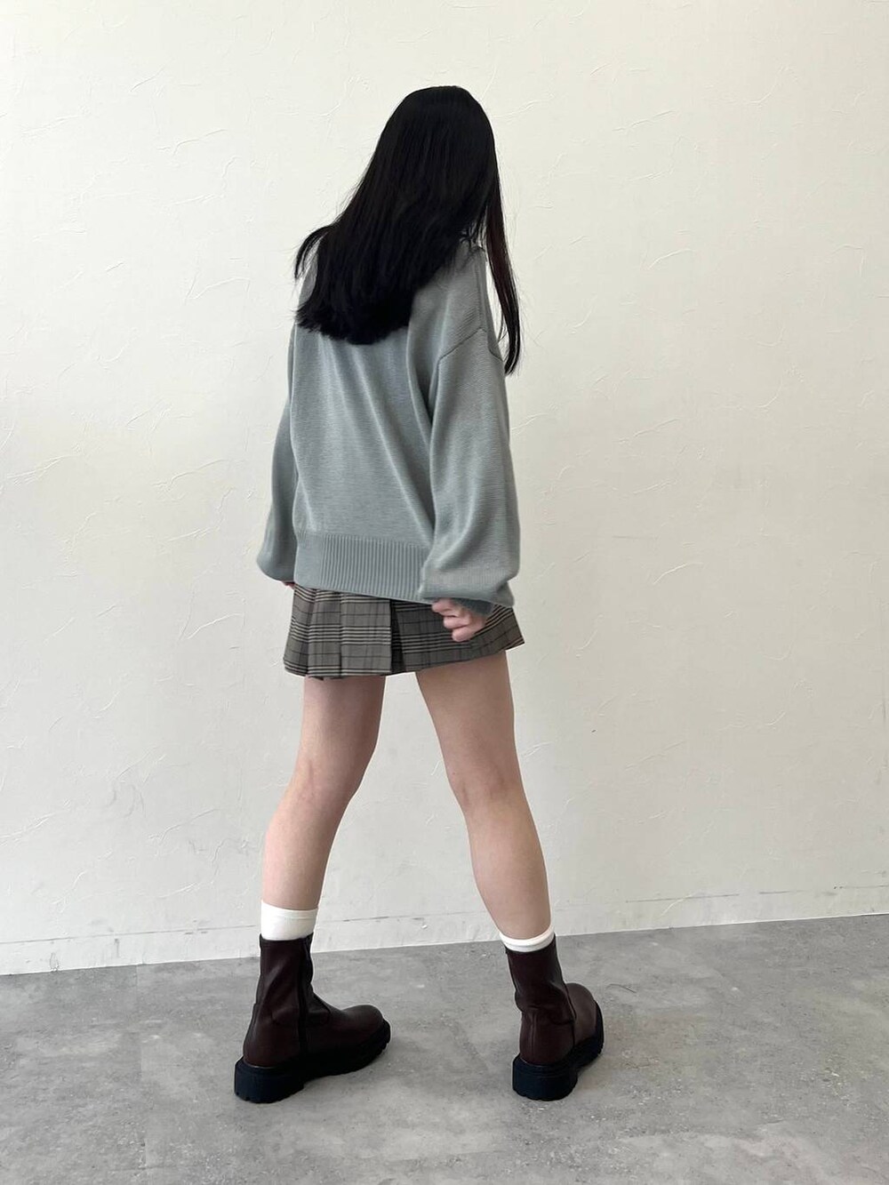 グレー系のニット/セーター、ブラウン系のスカート、ブラウン系のテーラードジャケットを着用したレディースの冬コーディネートの7枚目の写真