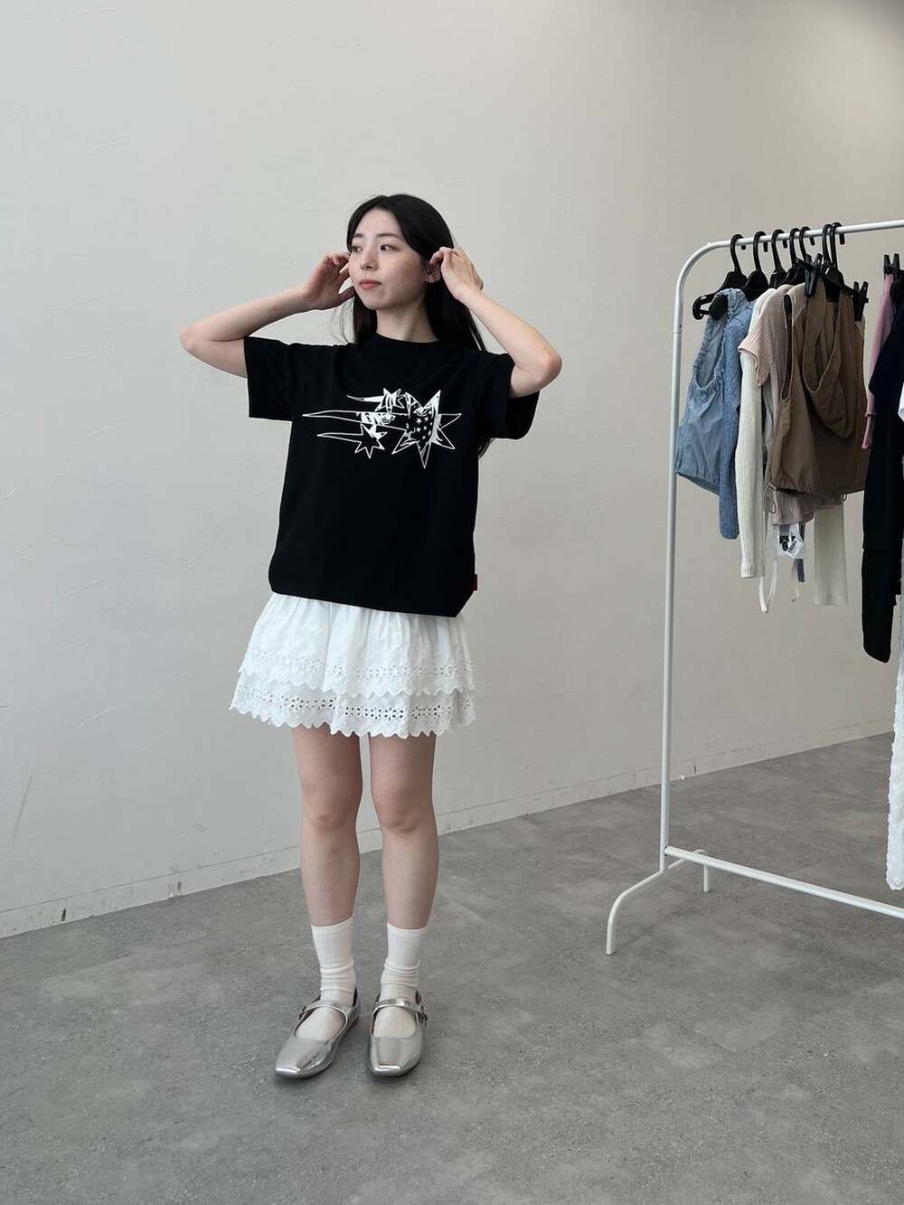 ホワイト系のスカート、ブラック系のTシャツ/カットソーを着用したレディースの夏コーディネートの5枚目の写真