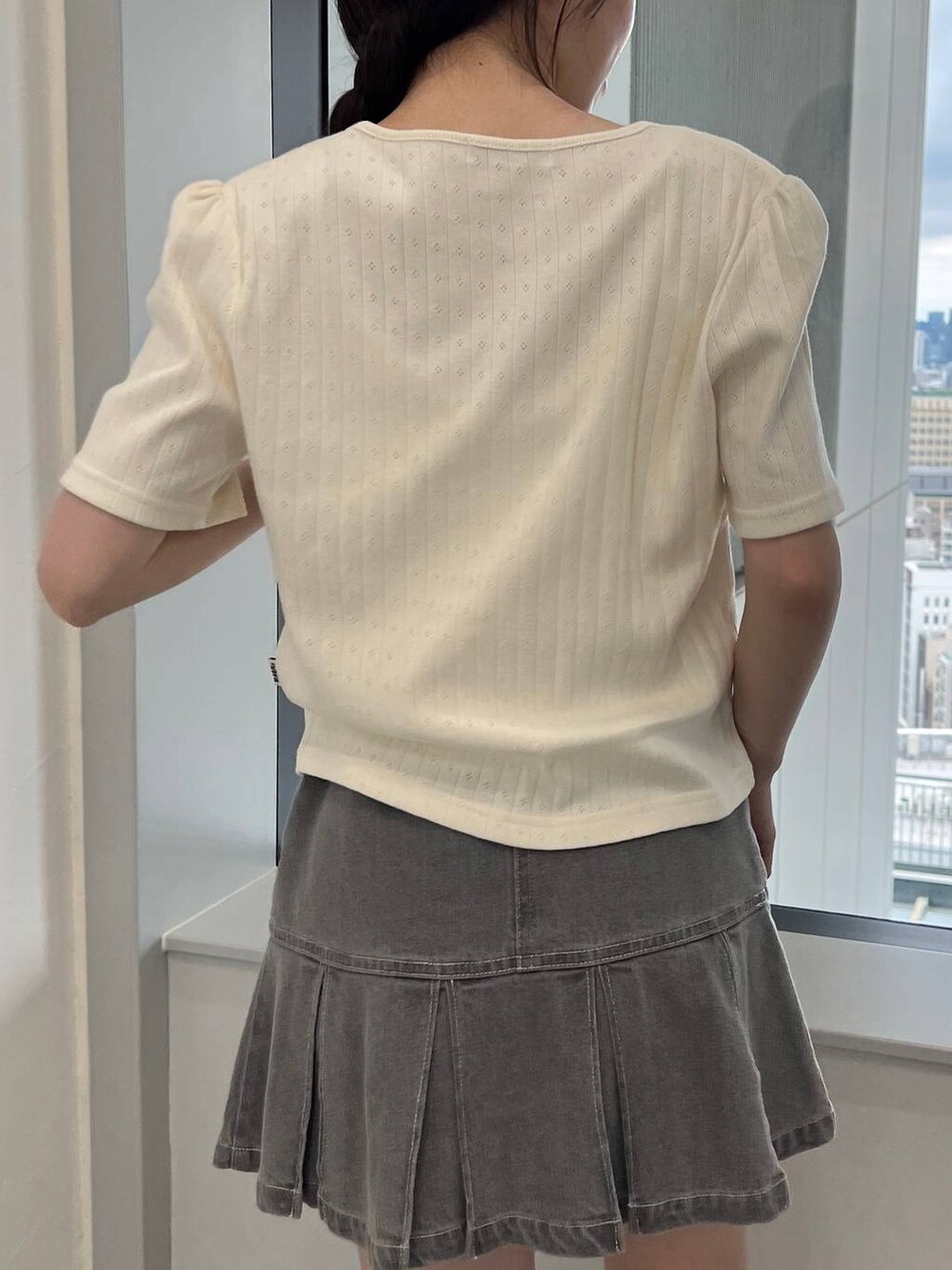 ベージュ系のカーディガン/ボレロ、グレー系のデニムスカートを着用したレディースの夏コーディネートの6枚目の写真