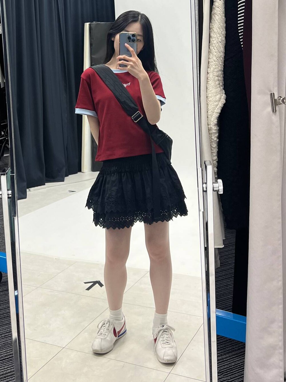 ブラック系のスカート、ブラック系のショルダーバッグを着用したレディースの夏コーディネートの6枚目の写真