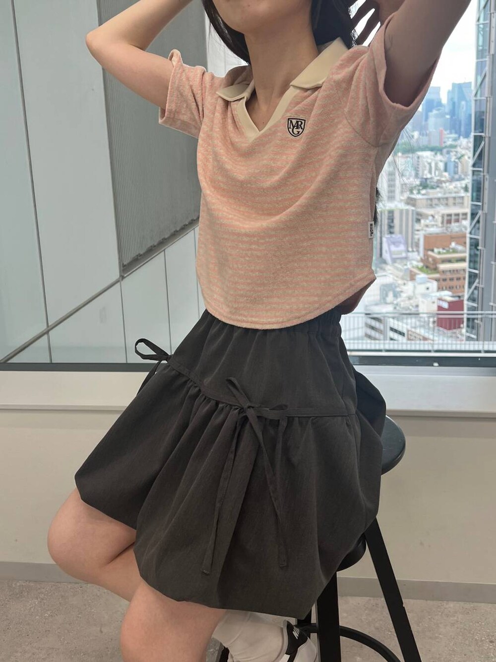 グレー系のスカート、ピンク系のTシャツ/カットソーを着用したレディースの夏コーディネートの3枚目の写真