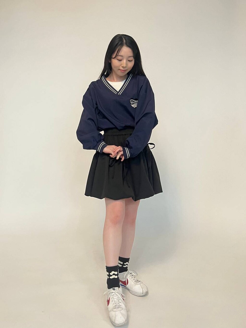 ブラック系のスウェット、ブラック系のスカートを着用したレディースの冬コーディネートの2枚目の写真