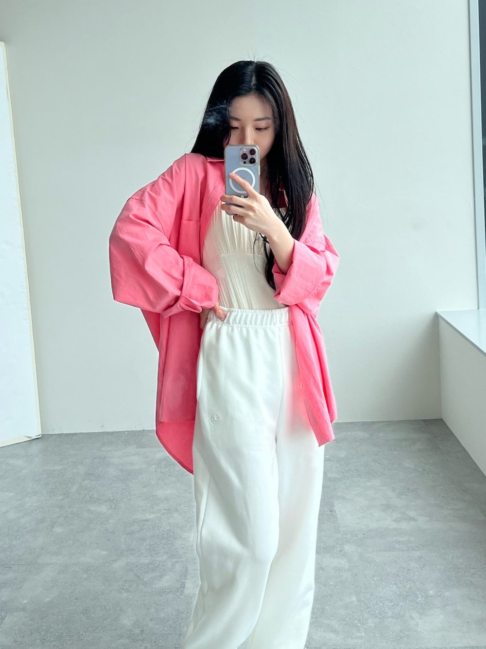 ベージュ系のスウェットパンツ、ピンク系のシャツ/ブラウス、ベージュ系のキャミソールを着用したレディースの春コーディネートの3枚目の写真