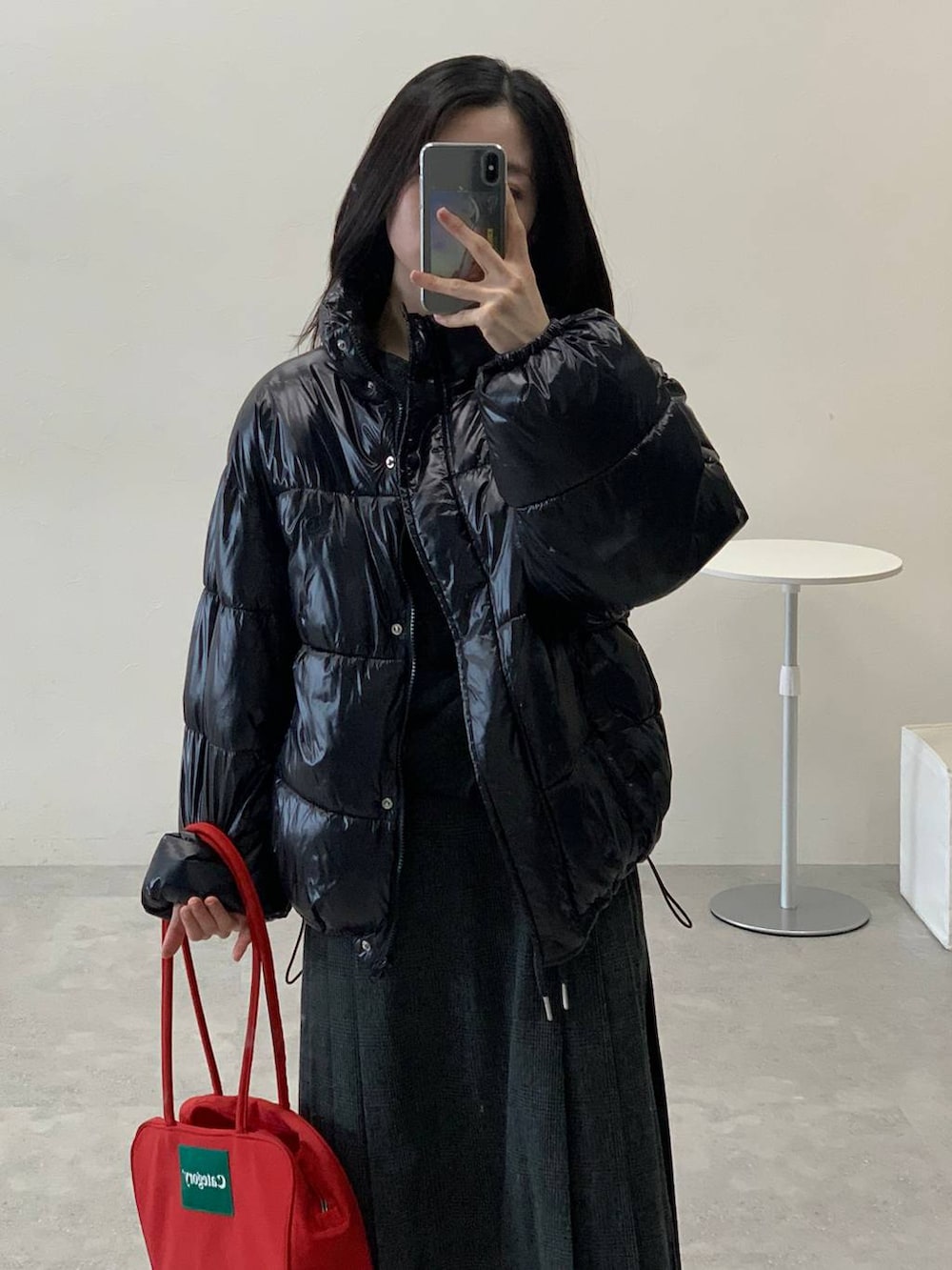 ブラック系のダウンジャケット/コート、グレー系のスカート、グレー系のTシャツ/カットソーを着用したレディースの冬コーディネートの10枚目の写真