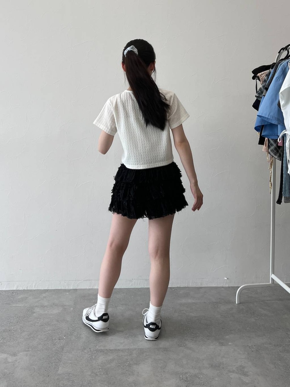 ホワイト系のTシャツ/カットソー、ブラック系のスカートを着用したレディースの夏コーディネートの6枚目の写真