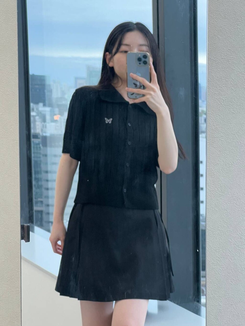 ブラック系のスカート、ブラック系のカーディガン/ボレロを着用したレディースの春コーディネートの4枚目の写真