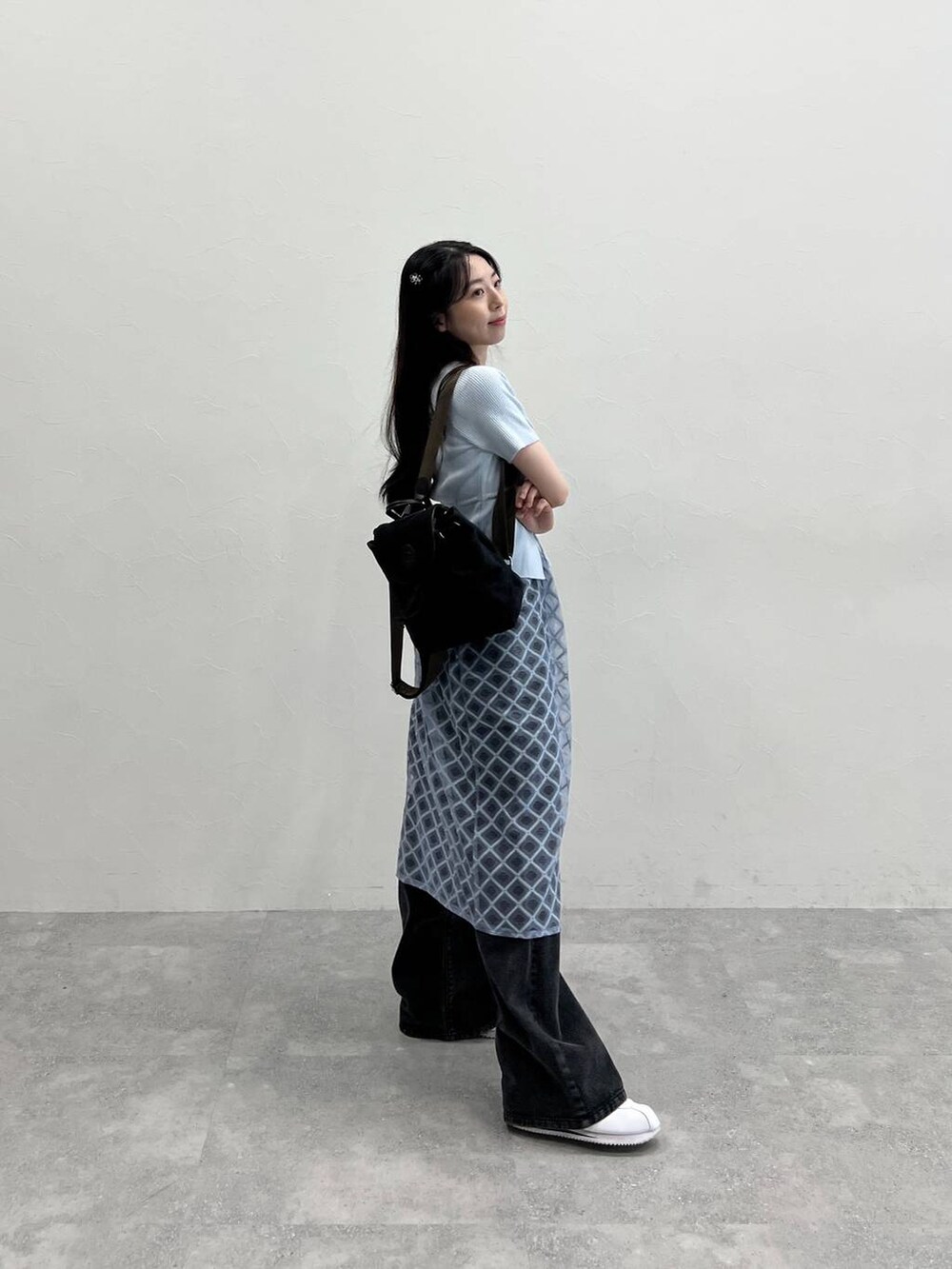 ブルー系のスカート、ブラック系のデニムパンツ、ブルー系のカーディガン/ボレロを着用したレディースの春コーディネートの5枚目の写真