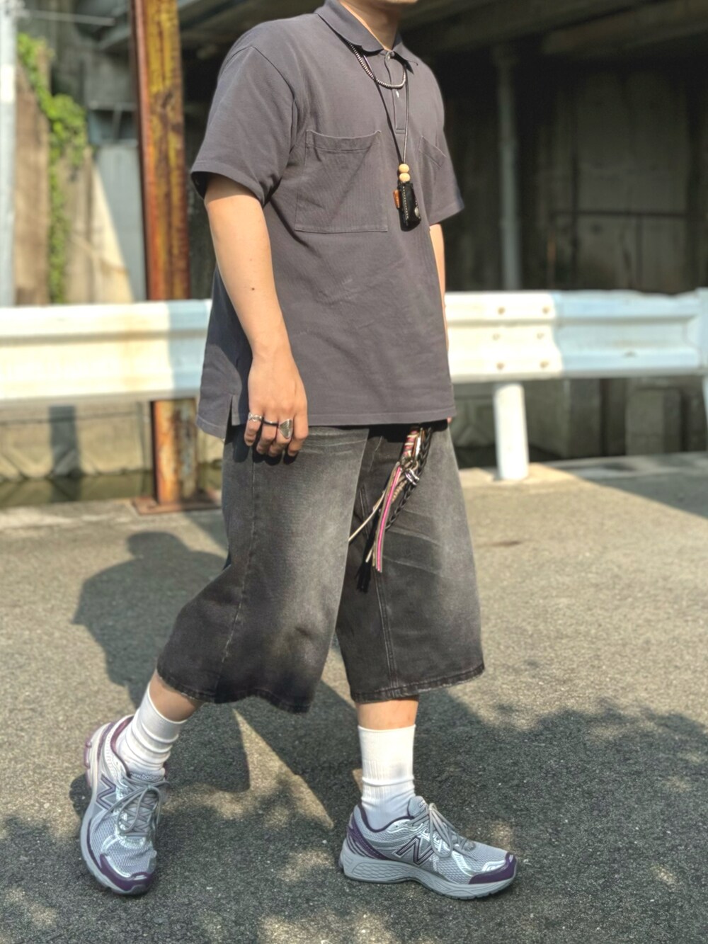 グレー系のポロシャツ、パープル系のスニーカー、グレー系のデニムパンツを着用したメンズの夏コーディネートの2枚目の写真