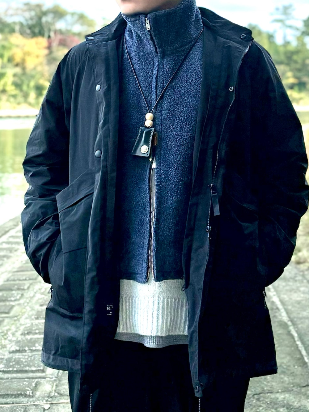 ブルー系のベスト、ブラック系のジャケット/アウター、グレー系のニット/セーターを着用したメンズの冬コーディネートの3枚目の写真