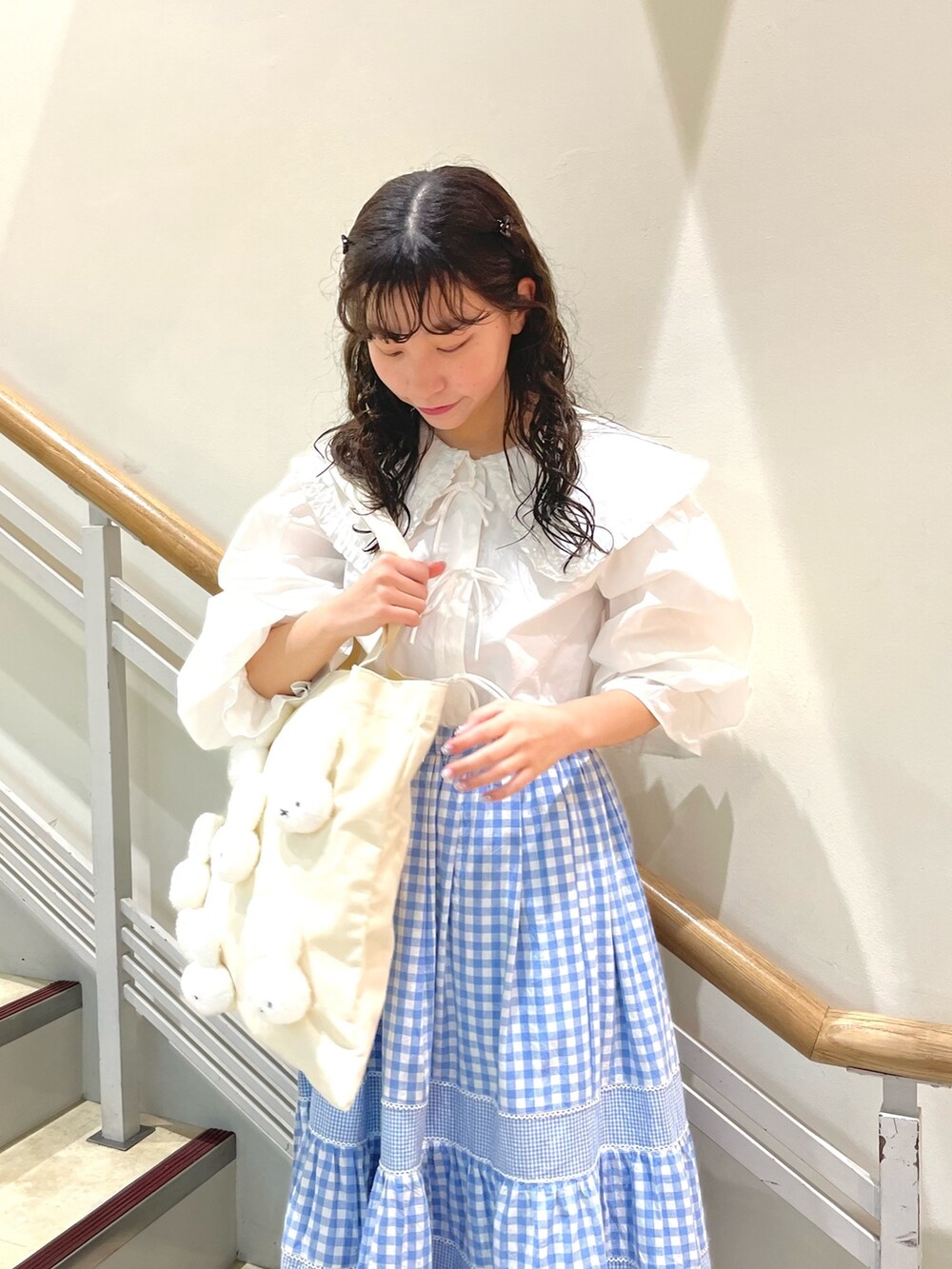 ホワイト系のシャツ/ブラウス、ブルー系のスカート、ホワイト系のトートバッグを着用したレディースの春コーディネートの3枚目の写真