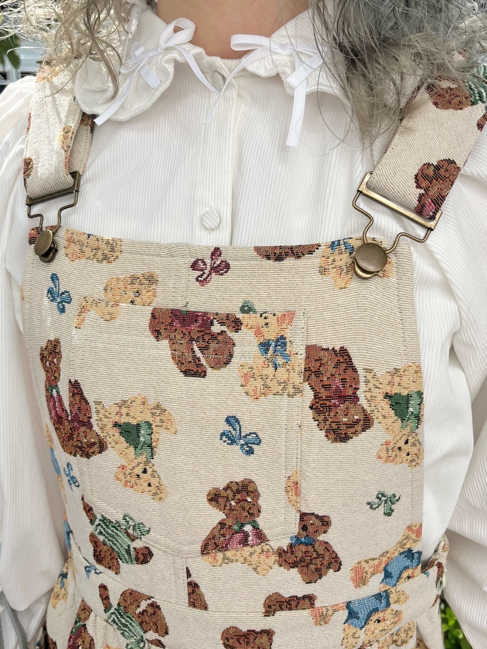ホワイト系のシャツ/ブラウス、ホワイト系のジャンパースカート、グレー系のショルダーバッグを着用したレディースの秋コーディネートの8枚目の写真