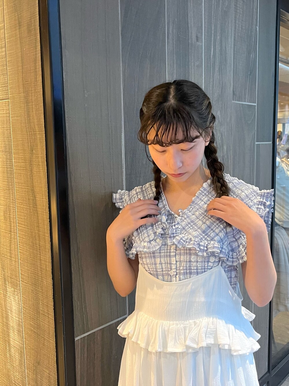 ブルー系のシャツ/ブラウス、ホワイト系のスカート、ブラウン系のパンプスを着用したレディースの春コーディネートの4枚目の写真