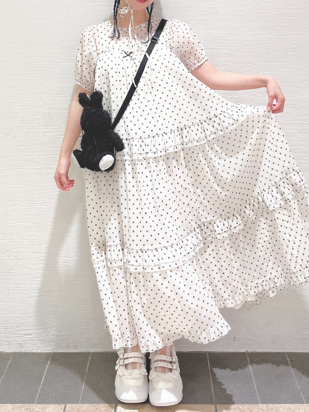 ホワイト系のワンピース、ブラック系のショルダーバッグ、ホワイト系のスニーカーを着用したレディースの春コーディネートの4枚目の写真