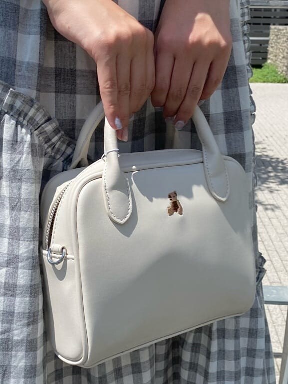 グレー系のスカート、ホワイト系のTシャツ/カットソー、ホワイト系のショルダーバッグを着用したレディースの夏コーディネートの5枚目の写真