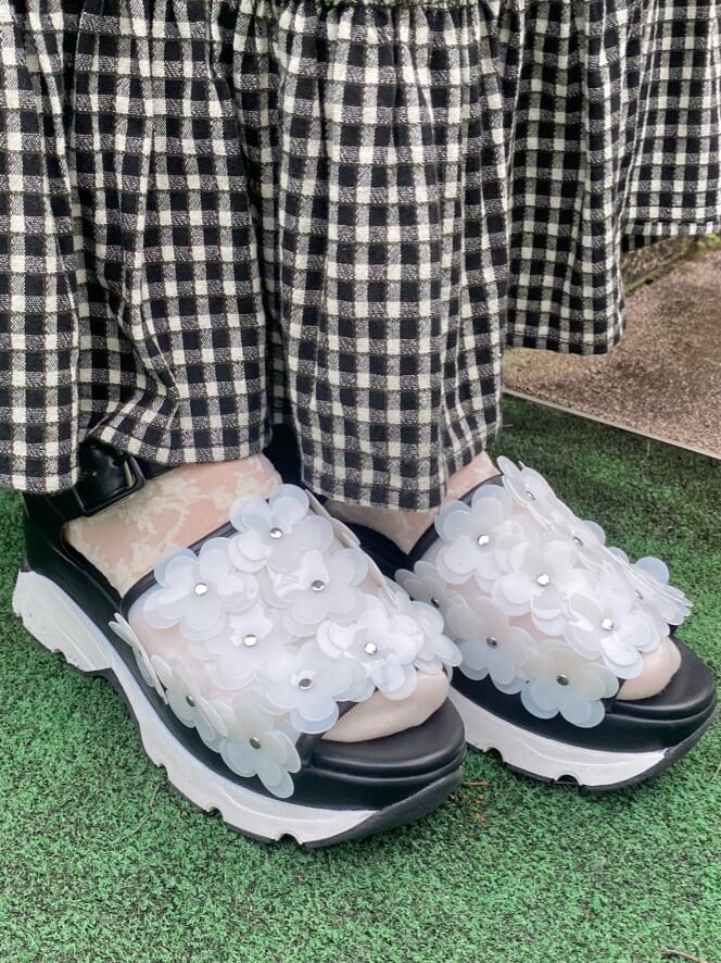 ブラック系のスカート、ブラック系のサンダル、ブラック系のショルダーバッグを着用したレディースの春コーディネートの7枚目の写真